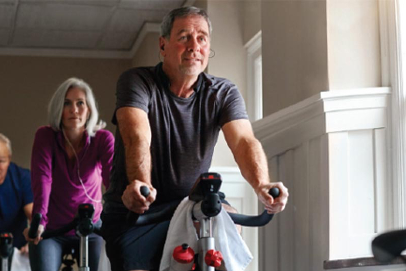 person exercising on riding bike